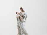 figurine of a woman holding a baby in her arms