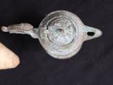 a small metal object that is on a black surface