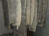 several pieces of cloth hanging from a rack in a room