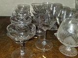 a lot of empty wine glasses on a wooden table