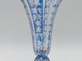 a blue and white vase sitting on a white surface