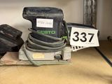 a sander on a shelf with a number on it