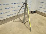 an image of a tripod in front of a wall