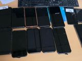 many cell phones and a keyboard on the table