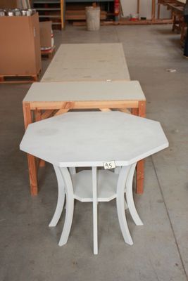 a table and two chairs in a warehouse area