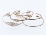 three silver rings on a white surface with a white background