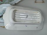 a white porcelain urinal sitting on a table next to a plate