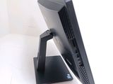 a computer monitor on a stand on a white surface