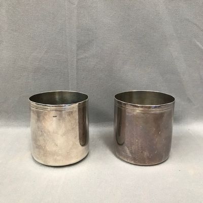 pair of silver plated cups with handles and handles