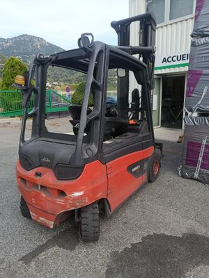 a red fork truck parked in front of a building
