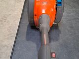 an orange and gray blow mop on the floor