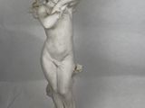 statue of a cheren angel holding a bird on a pedestal