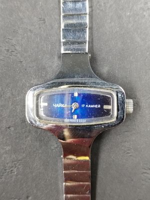 a close up of a wrist watch with a blue face