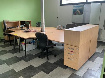 a desk with two chairs and a computer on top of it