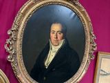 a painting of a man in a black coat on a pink wall
