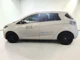 a small white car that is parked in a room