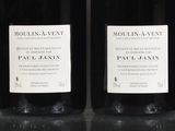 four bottles of wine are lined up on a table