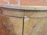 a wooden cabinet with two doors and a drawer