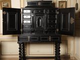 a black cabinet with a mirror on top of it