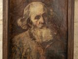 un vieux tableau représentant un homme barbu, dans un cadre en bois