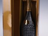 the bottle of champagne in the box is empty and ready to be opened