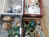 three boxes filled with various items on the floor