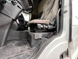 a seat in the back of a truck with a bag in it