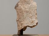 a small stone sculpture of a person on a block