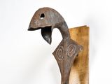 a sculpture of a bird that is on the wall