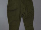 a close up of a pair of green pants on a gray surface