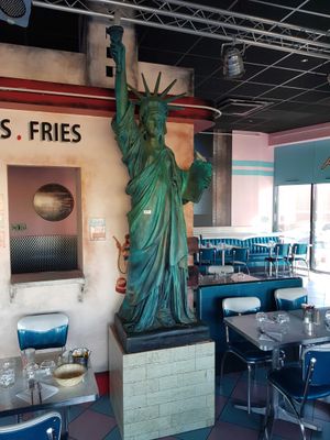 a statue of liberty on the wall of a restaurant
