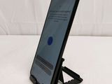 a close up of a cell phone on a stand on a white surface