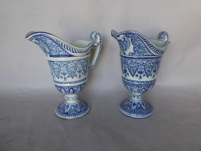 two blue and white vases sitting next to each other
