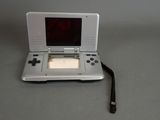 a small white nintendo game system on a table