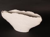 a white bowl that is sitting on a black table