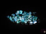 some very pretty blue diamonds on a black surface
