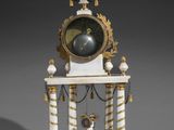 an image of a white and gold clock sitting on top of a table