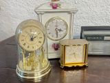 a small clock and a small clock on a table