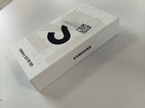 a white box on a table with a black logo on it