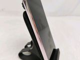 a close up of a cell phone on a stand on a table