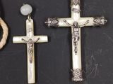 rosary and cross on a black surface with a rope