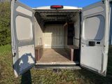 a white van with its door open in the grass