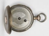 a close up of a pocket watch on a white surface