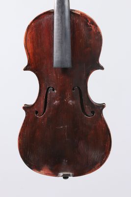 an old violin with a bow hanging from it ' s back