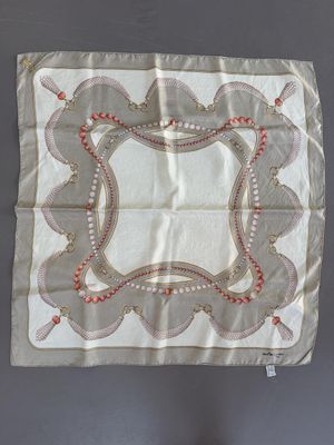 an old handkerchief with a design on it hanging on a wall