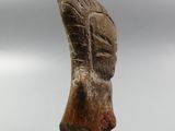 statue of a woman ' s head on a wooden stand against a cloudy sky