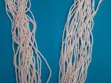 a close up of a string of pearls on a blue background