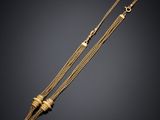 a gold necklace with a bar and a chain
