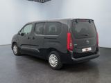 the small black van is parked in a large room
