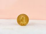 a gold coin sitting on top of a marble counter